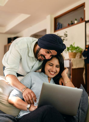 A man and woman looking at a computer
