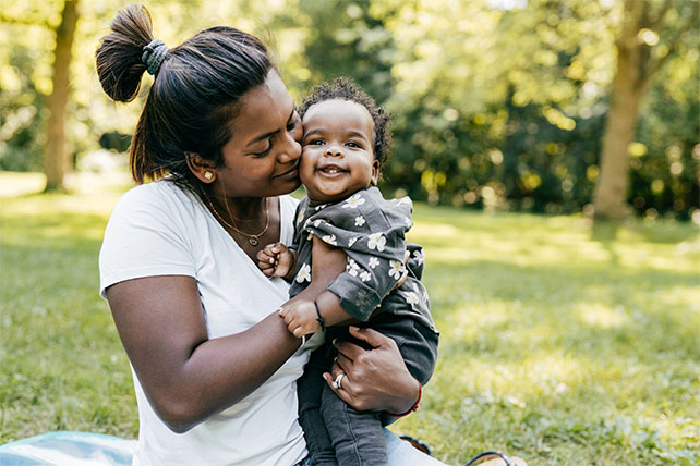 A smiling mother and child embrace